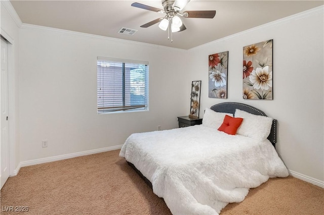 bedroom with ceiling fan, light colored carpet, ornamental molding, and a closet