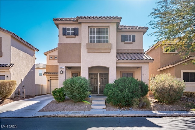 mediterranean / spanish-style home with a garage