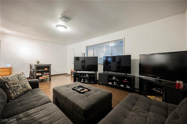 living room featuring wood finished floors and visible vents