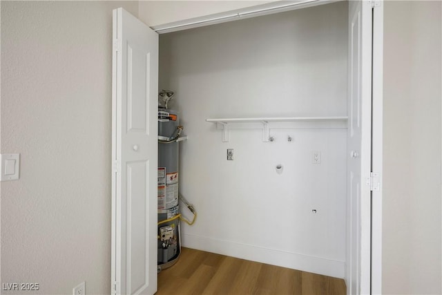 laundry room with gas water heater and light wood-type flooring