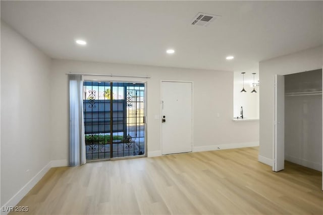 spare room featuring light wood-type flooring