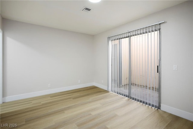 empty room with light hardwood / wood-style flooring