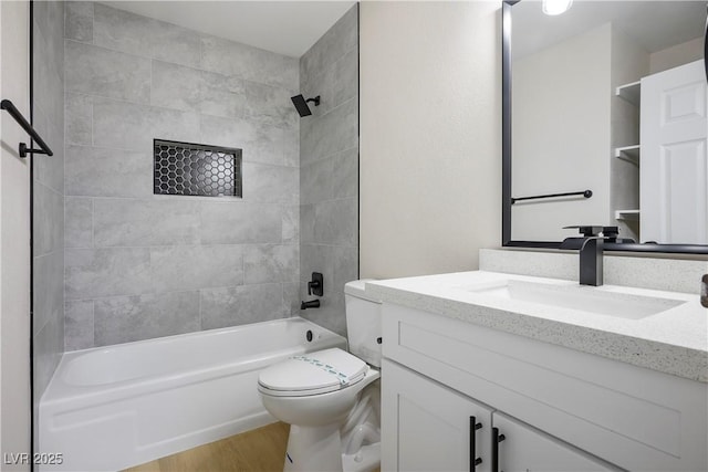 full bathroom featuring hardwood / wood-style flooring, vanity, toilet, and tiled shower / bath combo