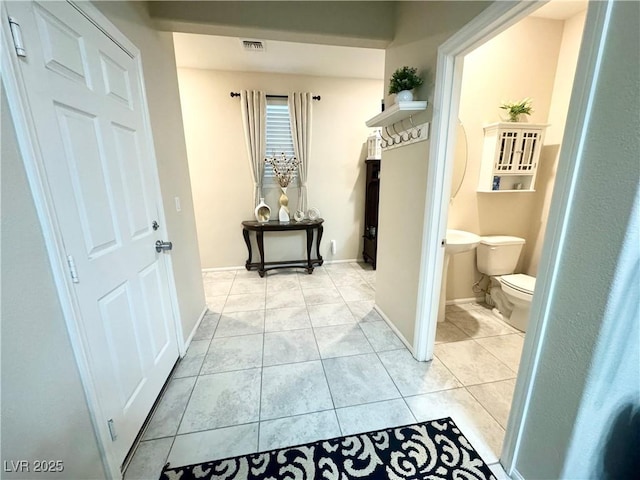 corridor with light tile patterned flooring