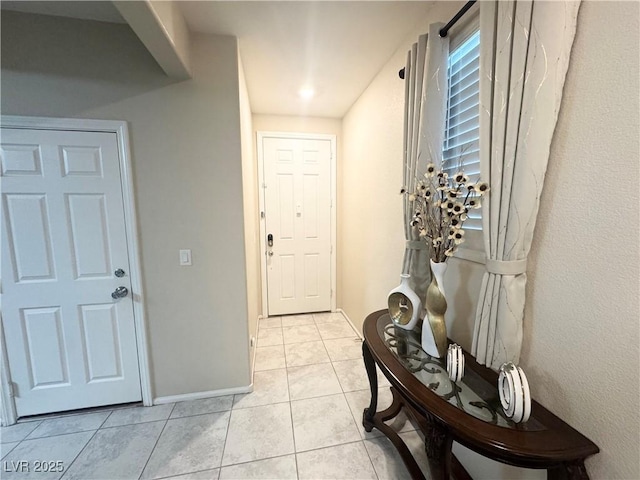 entryway with light tile patterned flooring