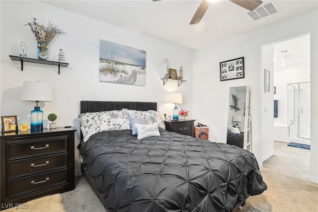 bedroom with light colored carpet, visible vents, ceiling fan, ensuite bath, and baseboards