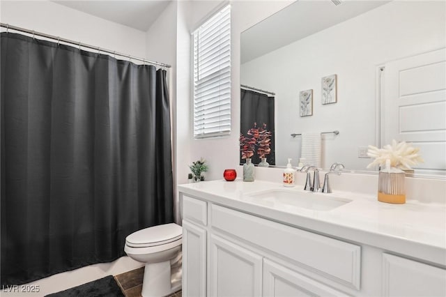 bathroom featuring toilet and vanity