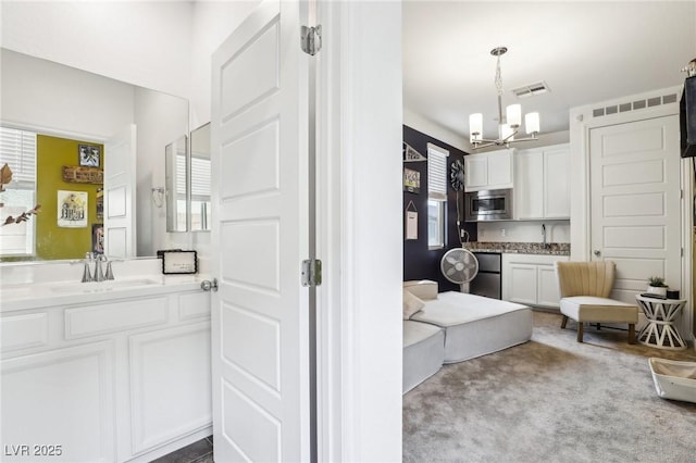 bathroom with visible vents, vanity, and an inviting chandelier