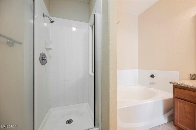 bathroom featuring vanity and plus walk in shower