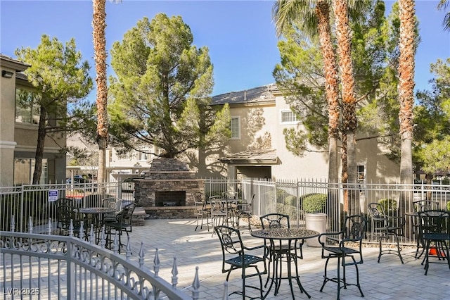 view of patio with an outdoor stone fireplace