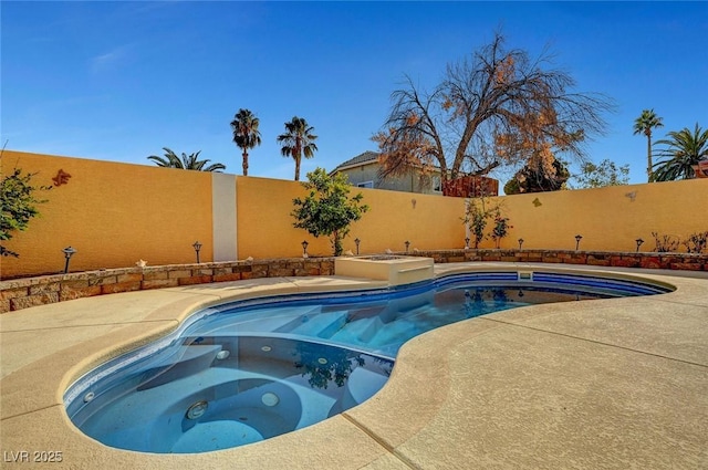 view of pool with an in ground hot tub