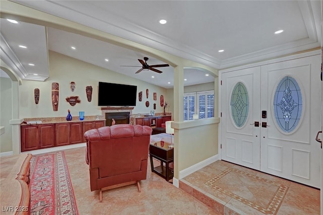 entryway with lofted ceiling, crown molding, french doors, and ceiling fan