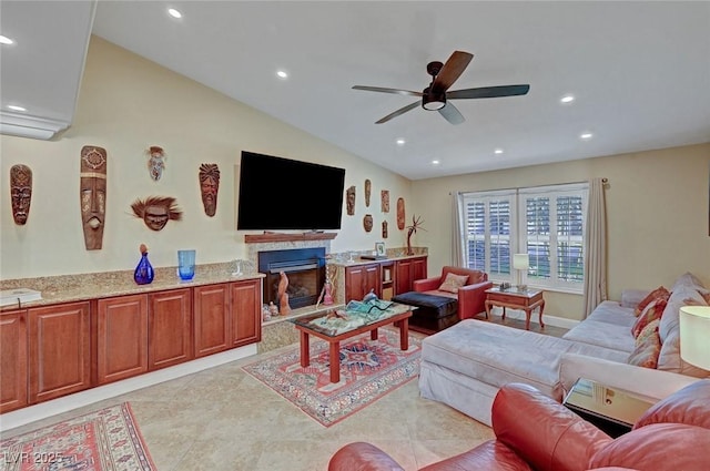 living room with light tile patterned flooring, ceiling fan, and vaulted ceiling