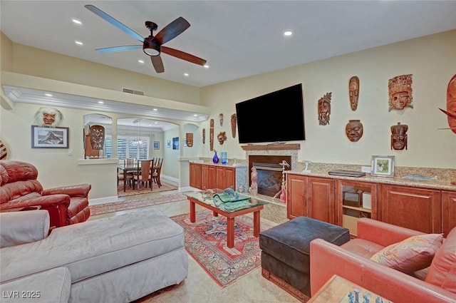 living room featuring ceiling fan and light tile patterned floors