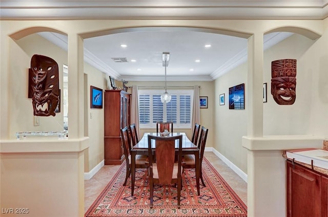 dining room with ornamental molding and light tile patterned floors