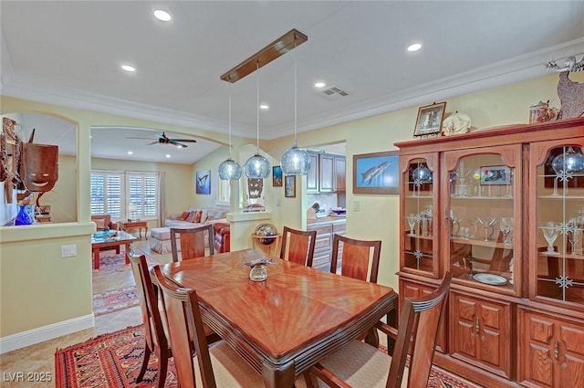 dining space featuring ornamental molding and ceiling fan