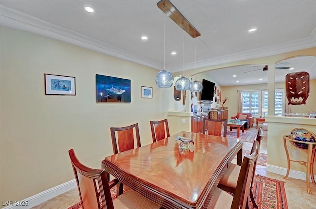 dining area featuring ceiling fan and ornamental molding