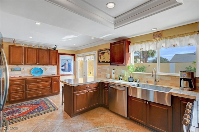 kitchen featuring dishwasher, sink, decorative backsplash, kitchen peninsula, and crown molding