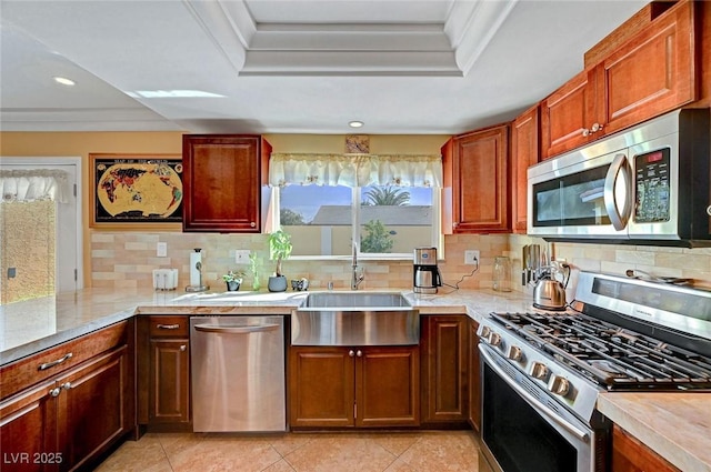 kitchen with tasteful backsplash, sink, a raised ceiling, and appliances with stainless steel finishes