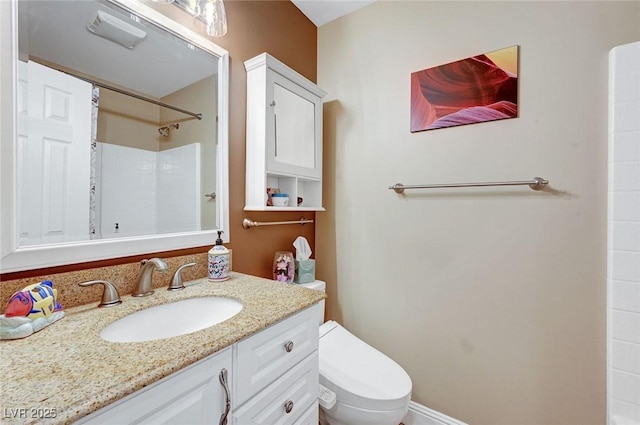 bathroom with vanity, toilet, and walk in shower