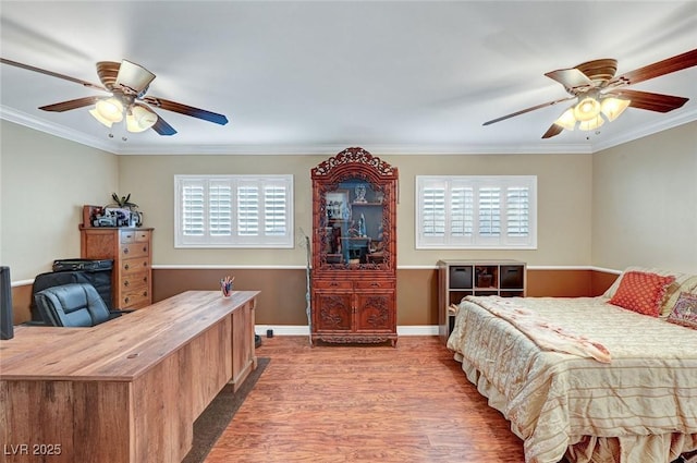 bedroom featuring crown molding, hardwood / wood-style floors, and multiple windows