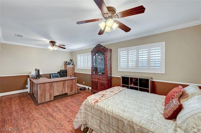 bedroom featuring hardwood / wood-style floors, ornamental molding, and ceiling fan