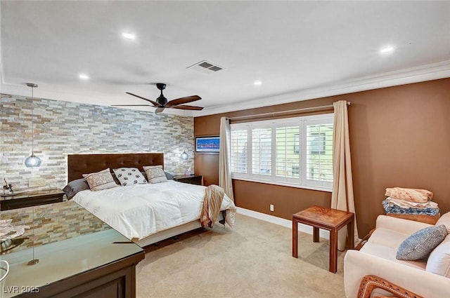 carpeted bedroom with crown molding and ceiling fan