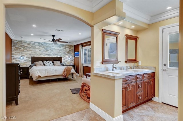 carpeted bedroom with ornamental molding and sink