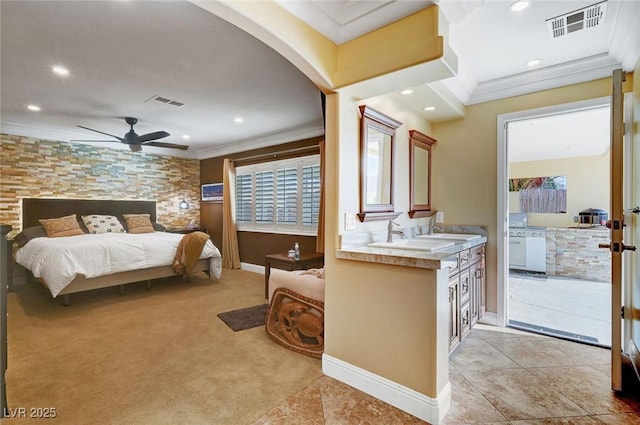 bedroom featuring crown molding, light colored carpet, and sink