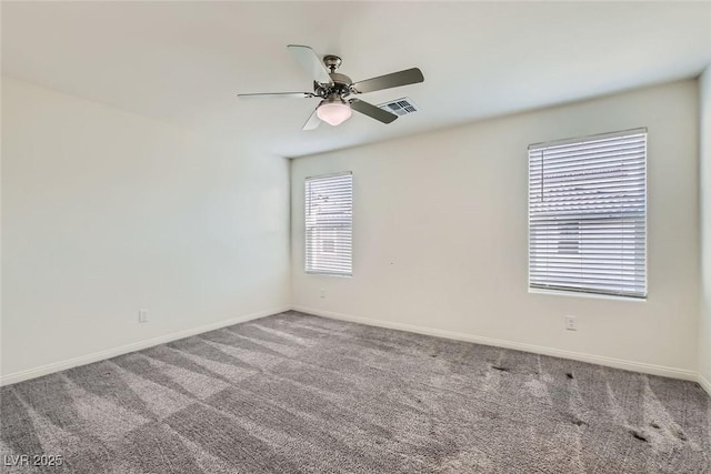 unfurnished room with ceiling fan and carpet