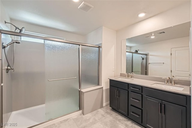 bathroom featuring vanity and an enclosed shower