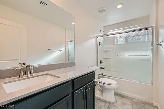 full bathroom featuring vanity, combined bath / shower with glass door, and toilet