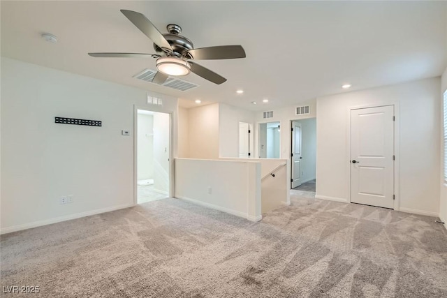 carpeted spare room featuring ceiling fan