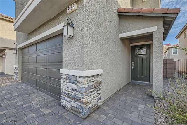 doorway to property with a garage