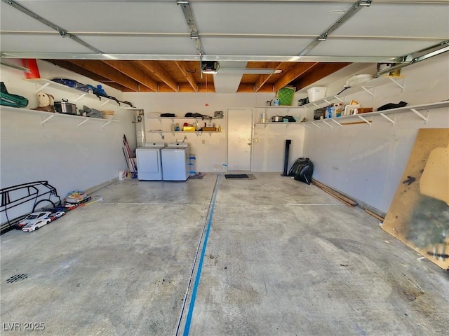 garage featuring a garage door opener and independent washer and dryer