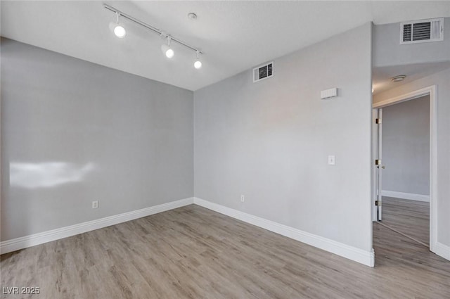 spare room with hardwood / wood-style floors