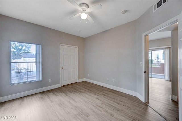 spare room featuring hardwood / wood-style flooring and ceiling fan