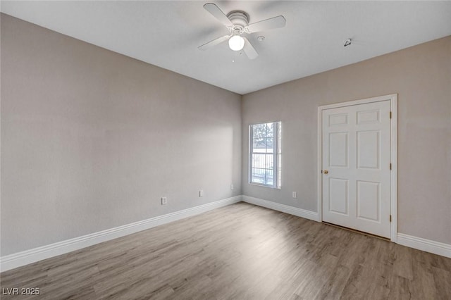 unfurnished room with ceiling fan and light wood-type flooring