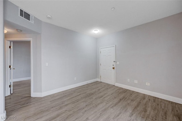 unfurnished room with light hardwood / wood-style flooring