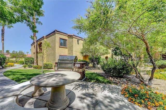 view of patio / terrace featuring an outdoor kitchen and a grill