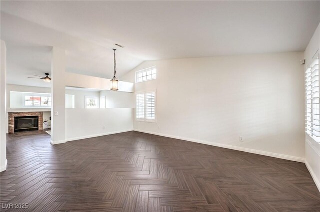 spare room featuring ceiling fan, dark parquet flooring, and high vaulted ceiling