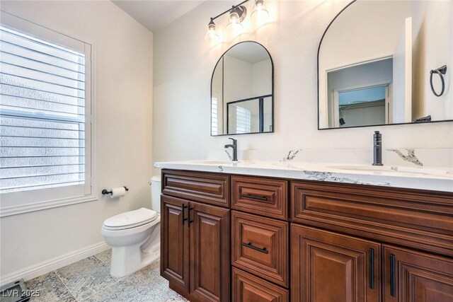 bathroom with tile patterned flooring, vanity, and toilet