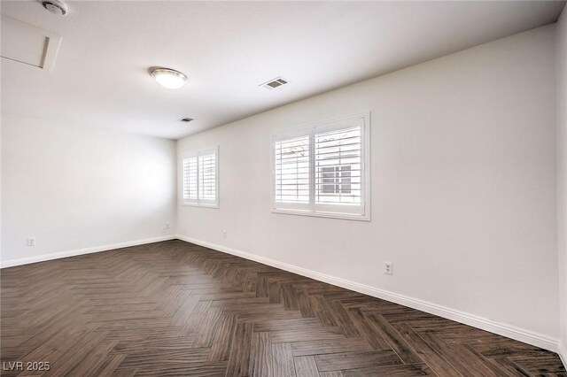 unfurnished room with dark parquet flooring