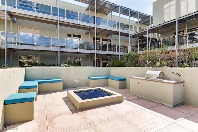 view of patio / terrace with area for grilling, grilling area, and a fire pit