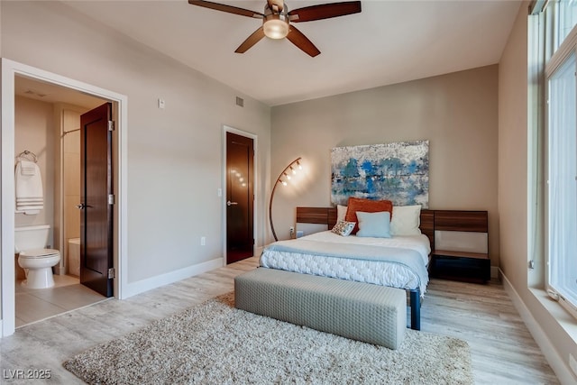 bedroom featuring connected bathroom, ceiling fan, and light hardwood / wood-style flooring