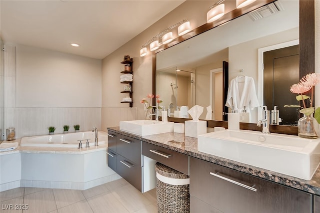 bathroom with vanity, tile patterned floors, and plus walk in shower