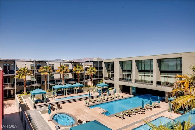 view of pool featuring a patio area and a hot tub