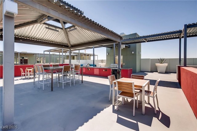 view of patio / terrace featuring a bar and a gazebo