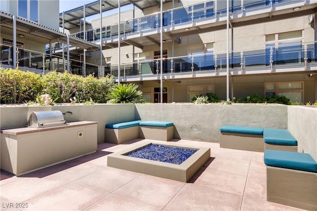 view of patio featuring exterior kitchen and grilling area