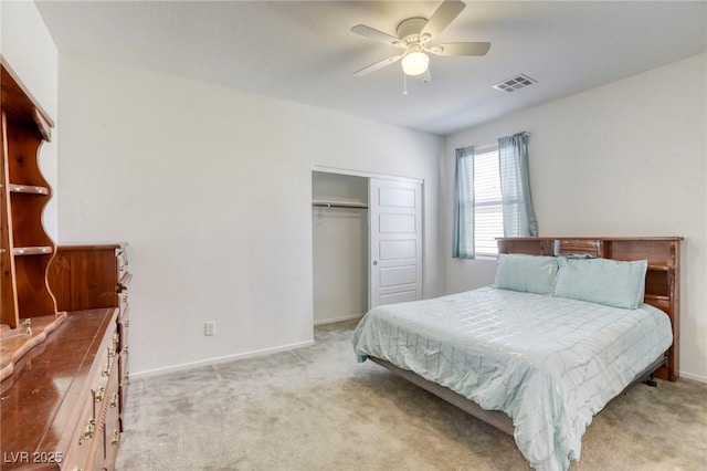 bedroom with light colored carpet, visible vents, a closet, and baseboards